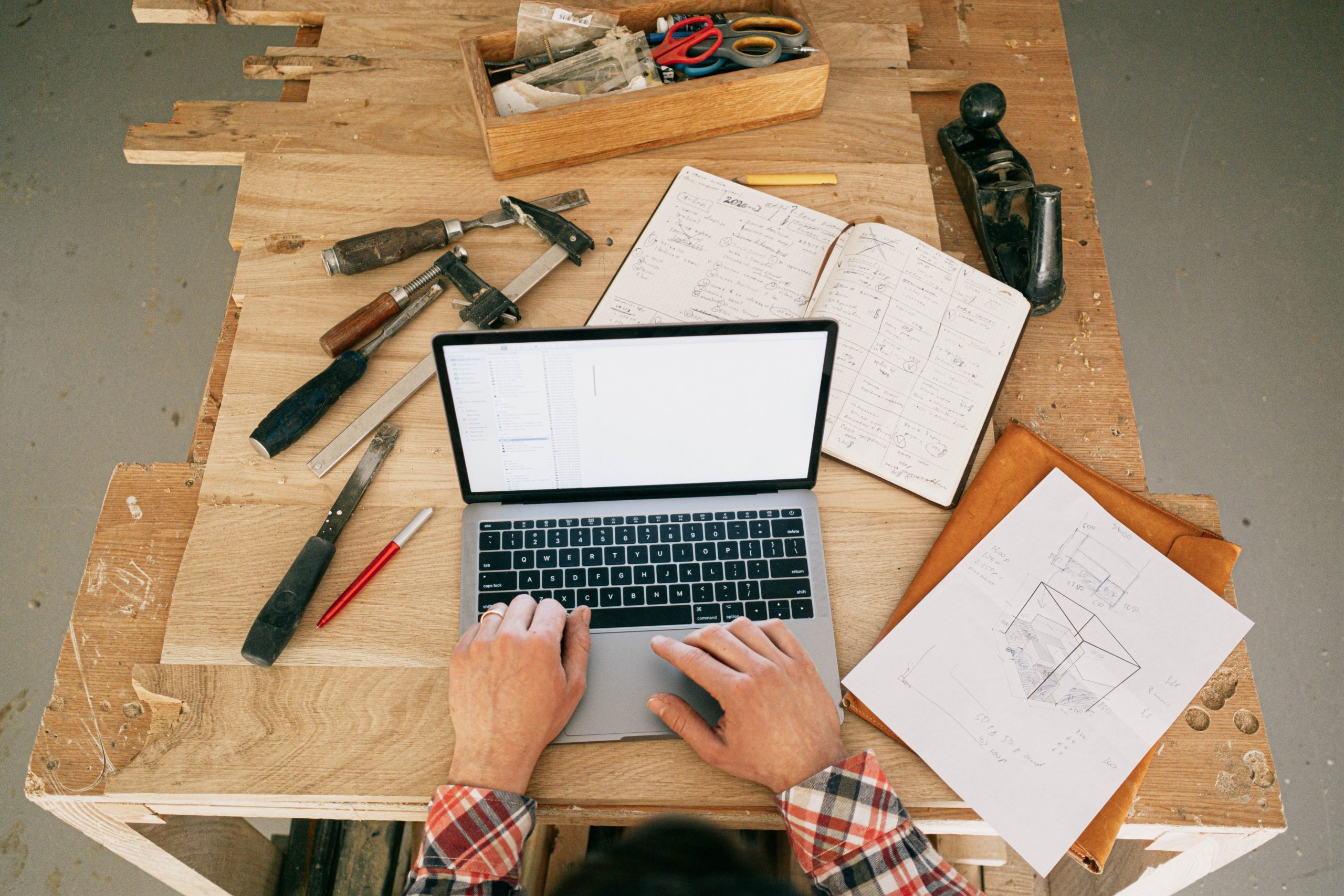 A laptop surrounded by tools